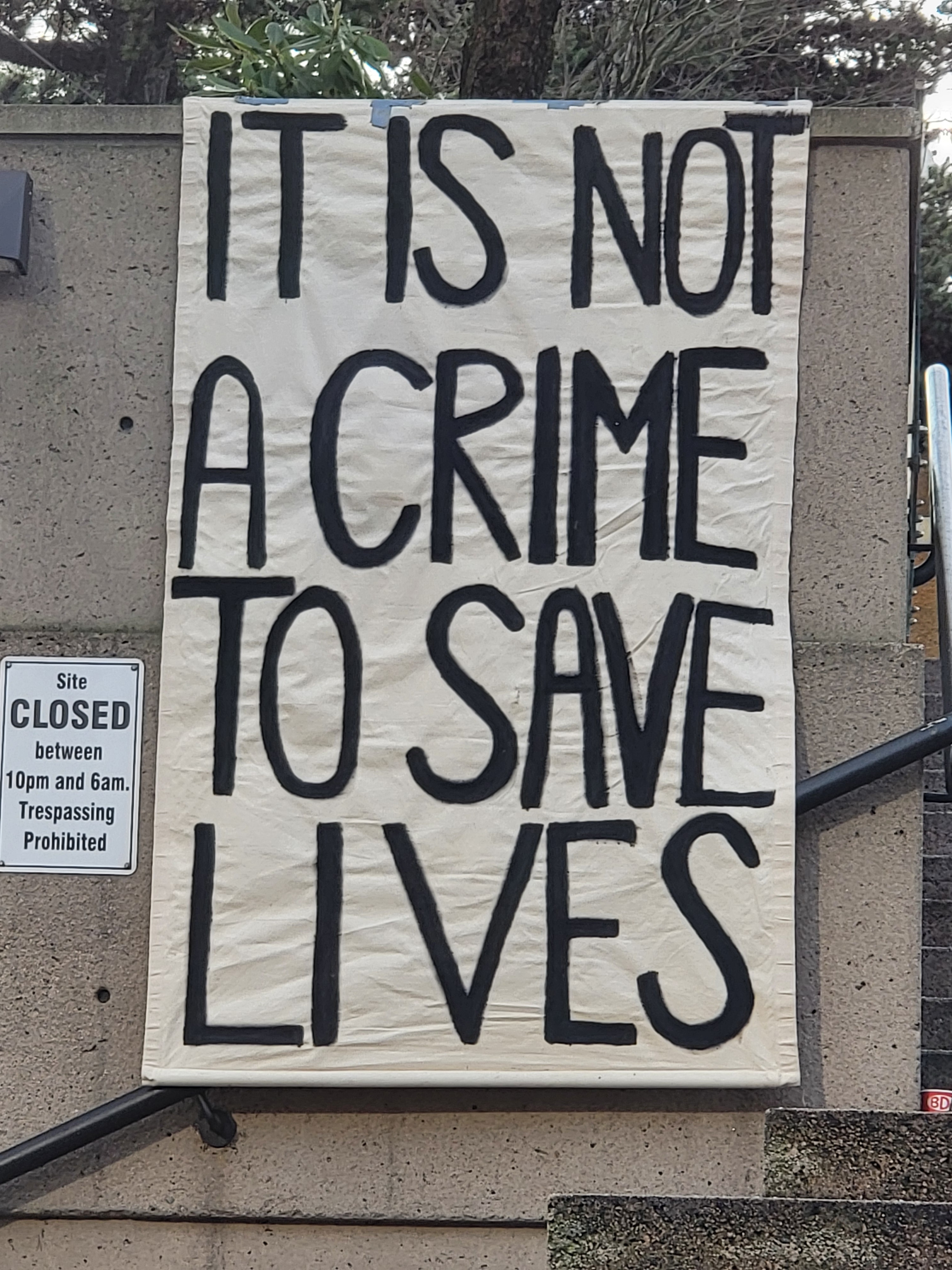 It is not a crime to save lives banner.