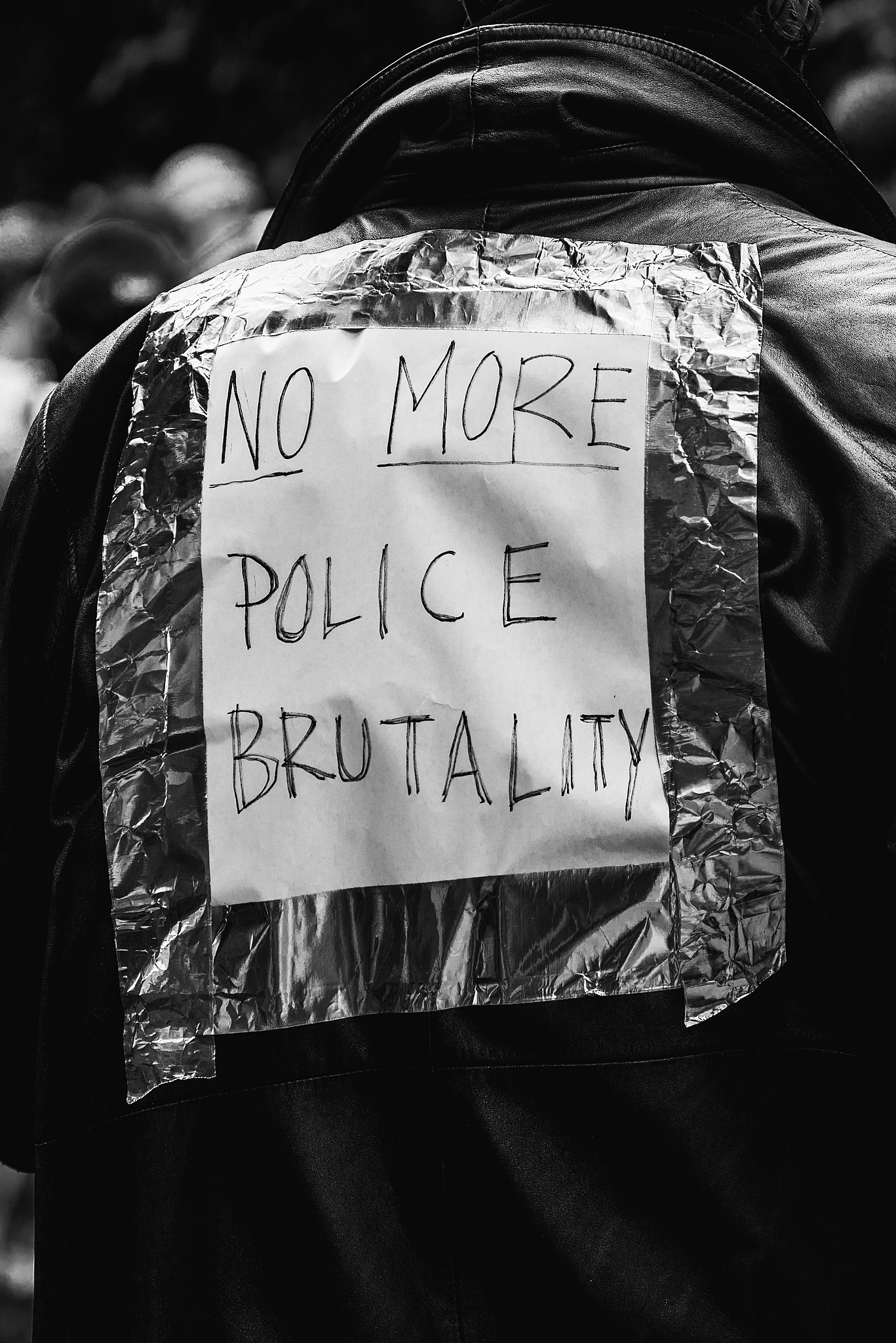 Text on a jacket reading "No more police brutality." Taken at racial justice protests in Toronto in 2020 by Jason Hargrove, obtained via Wikimedia.