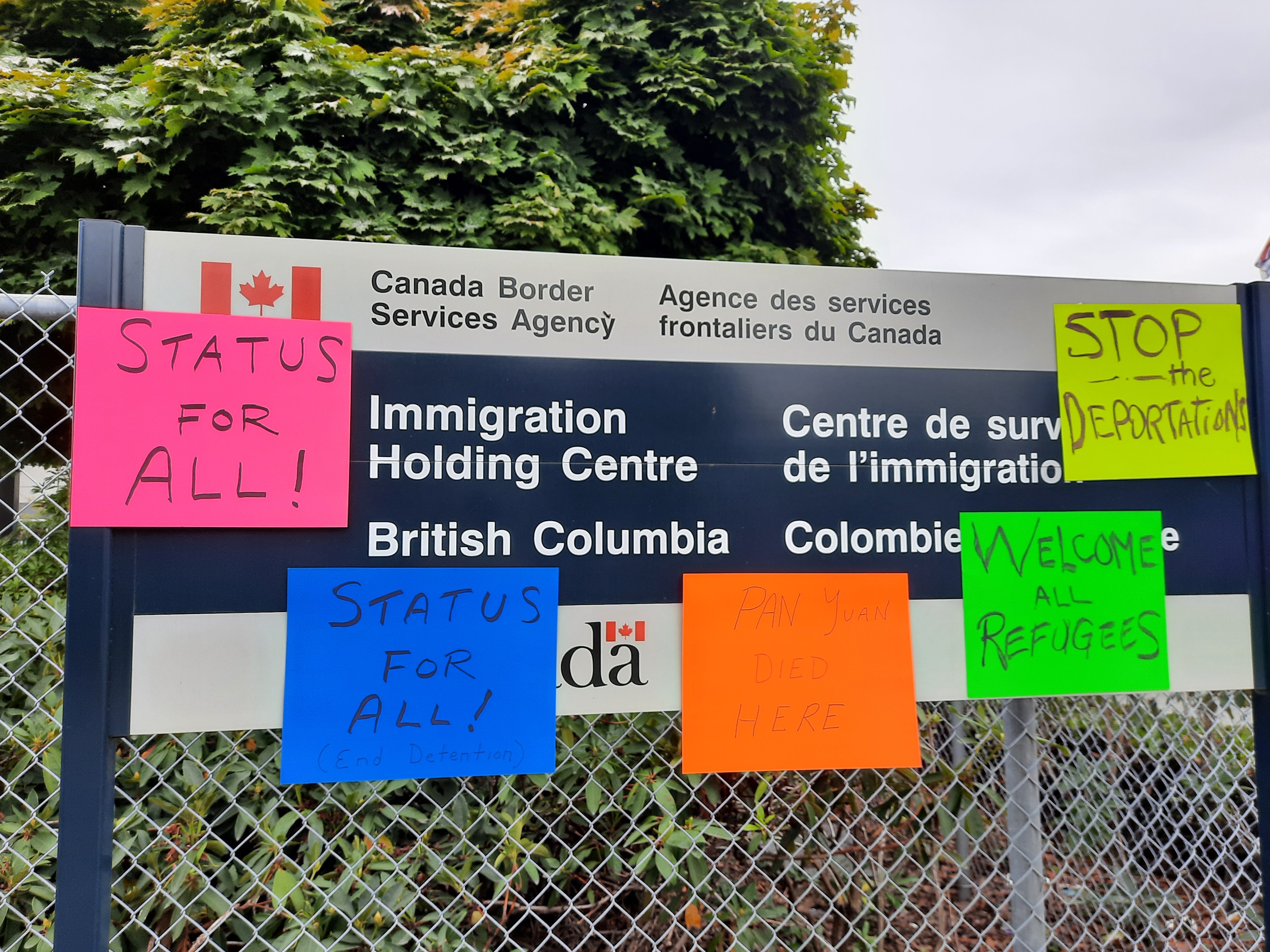 Status for all posters on migrant detention sign in Surrey.