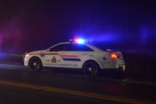 RCMP vehicle with lights on at night.