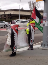 Protesters with Palestine flags and signs.