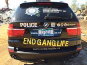 Police car with "End Gang Life" painted on it.